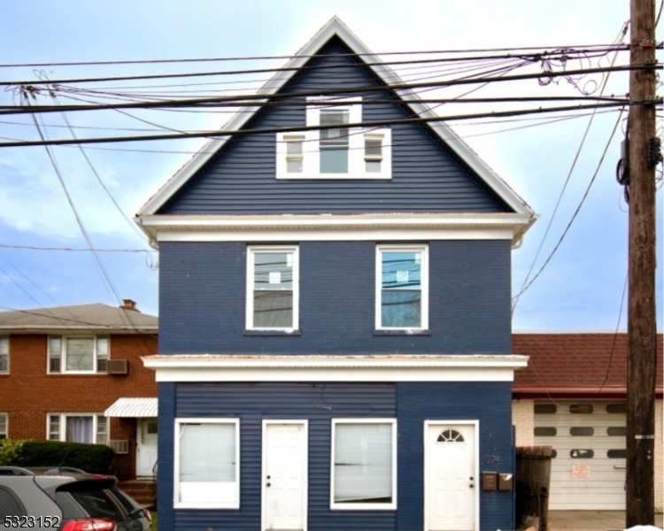 a view of a house with a garage and balcony