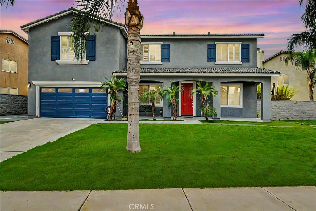 a front view of a house with a garden