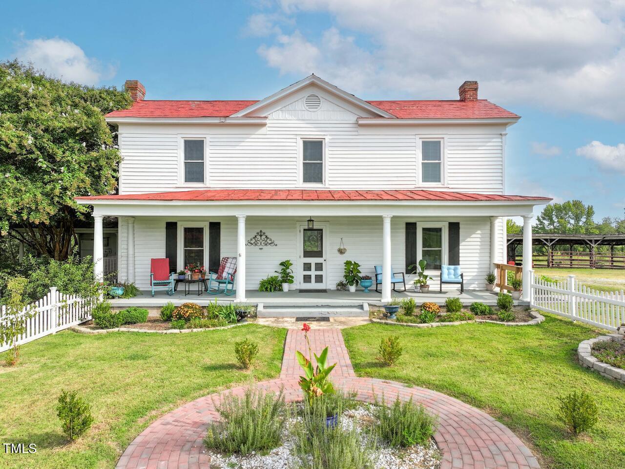 a view of a house with a yard patio and swimming pool