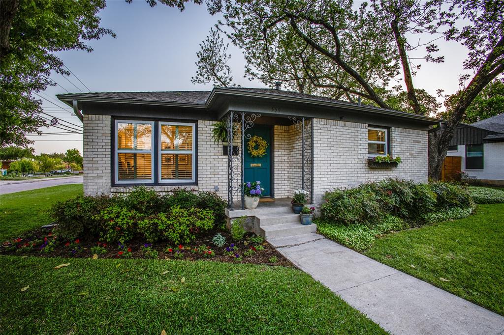 a front view of house with yard and green space