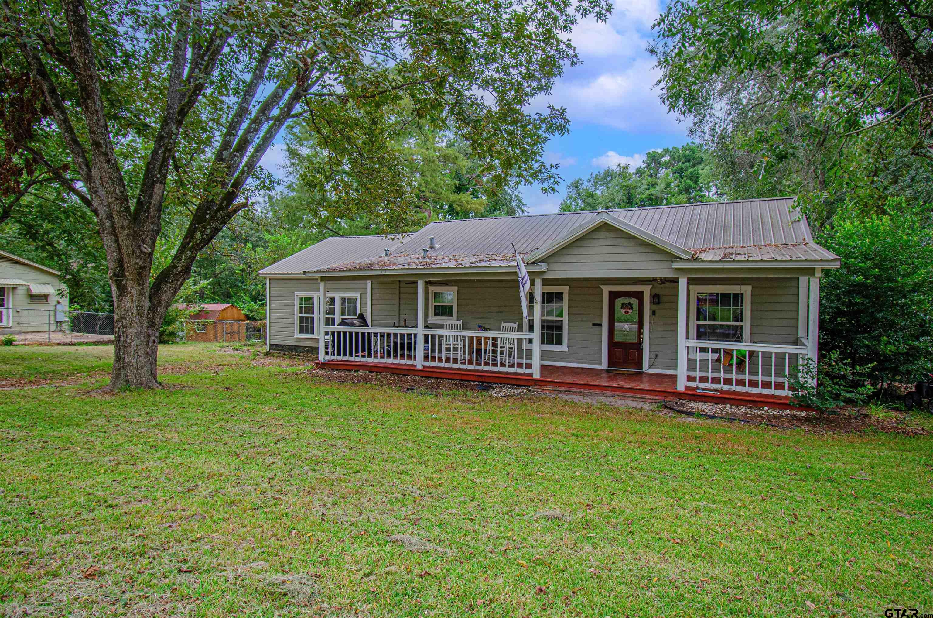 a front view of a house with a garden and porch