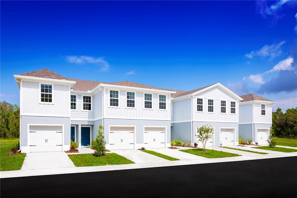 a front view of a house with a garden and yard