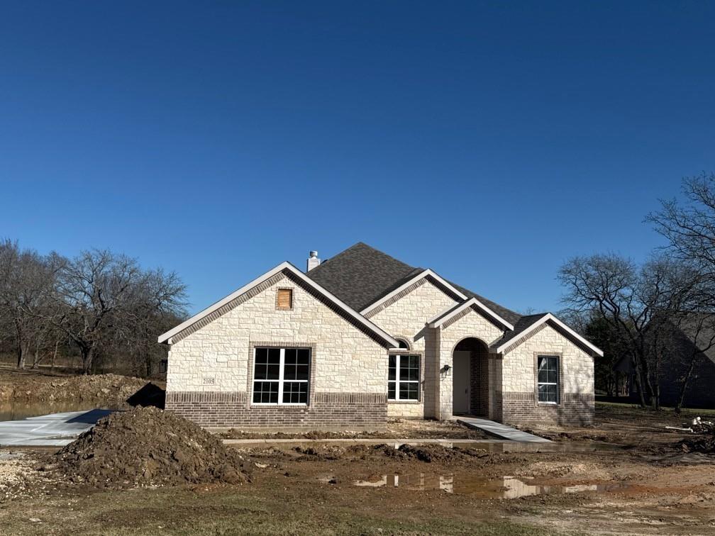 a front view of a house with a yard