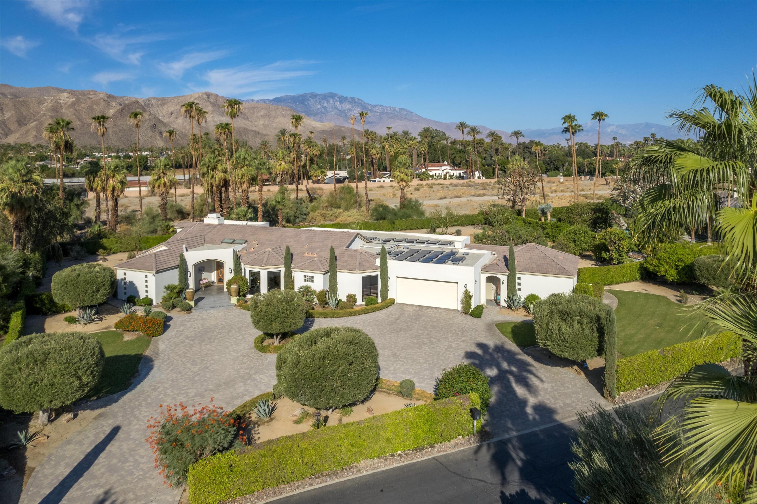 an aerial view of a house with a yard basket ball court and outdoor seating