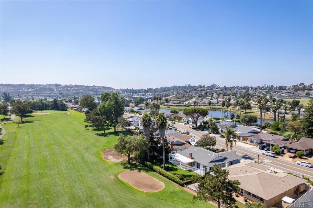 an aerial view of residential houses with outdoor space and trees