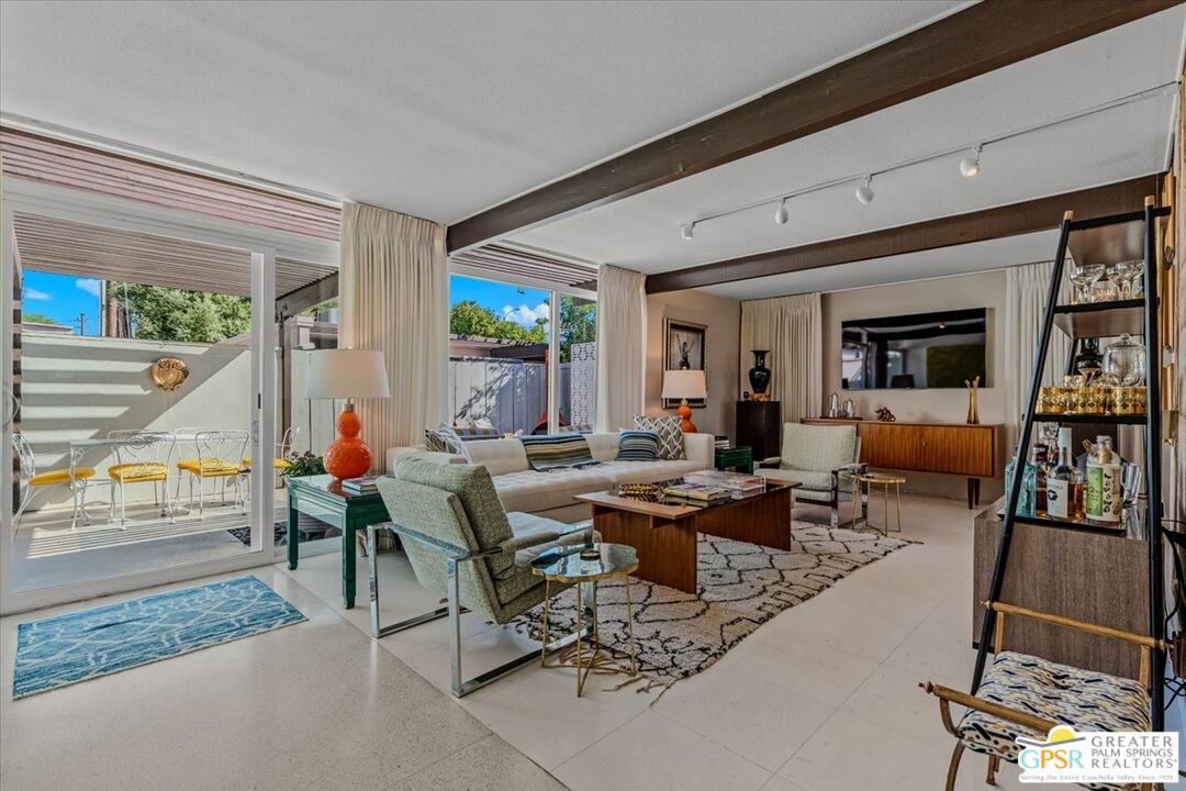 a living room with lots of furniture and a flat screen tv