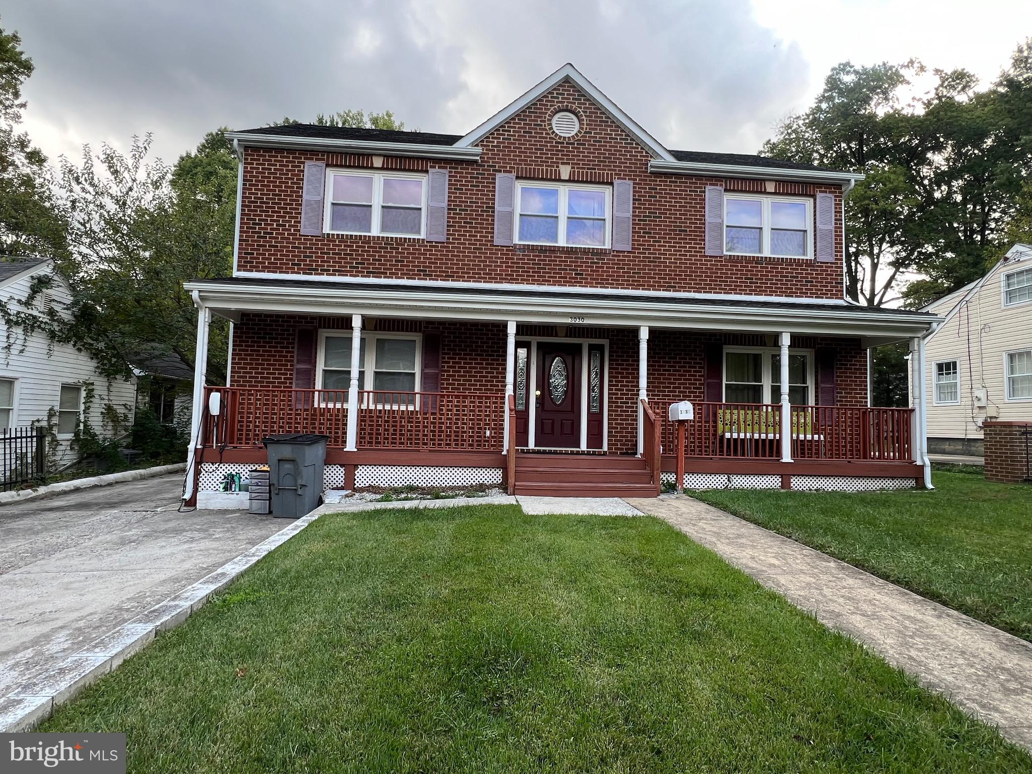 front view of brick house with a yard