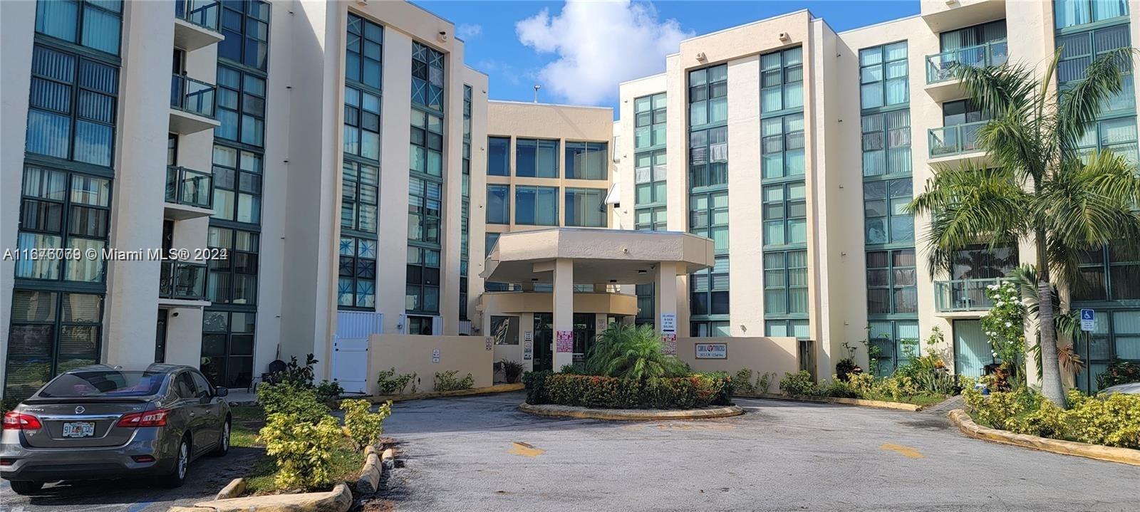 a front view of a building with a garden