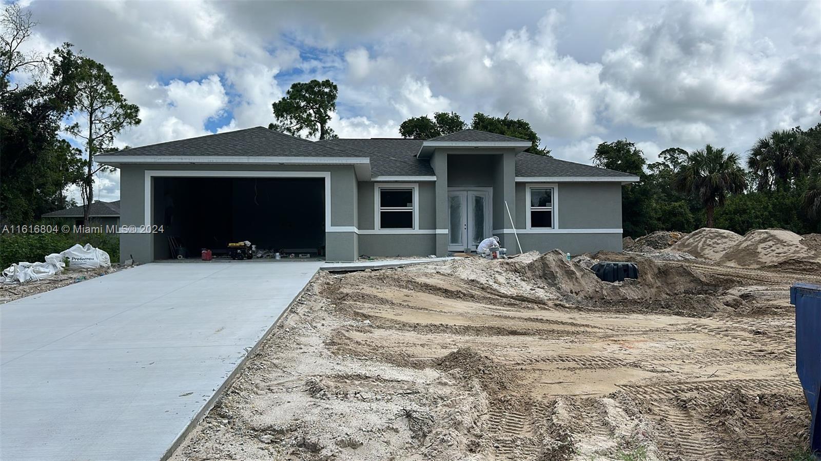 a view of a house with a yard and garage