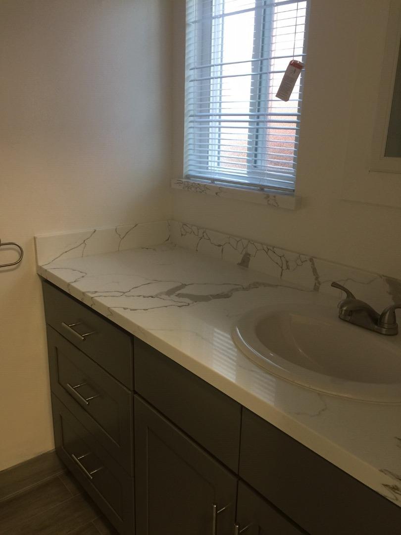 a bathroom with a sink and a window