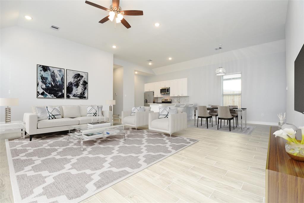 a living room with furniture and kitchen view