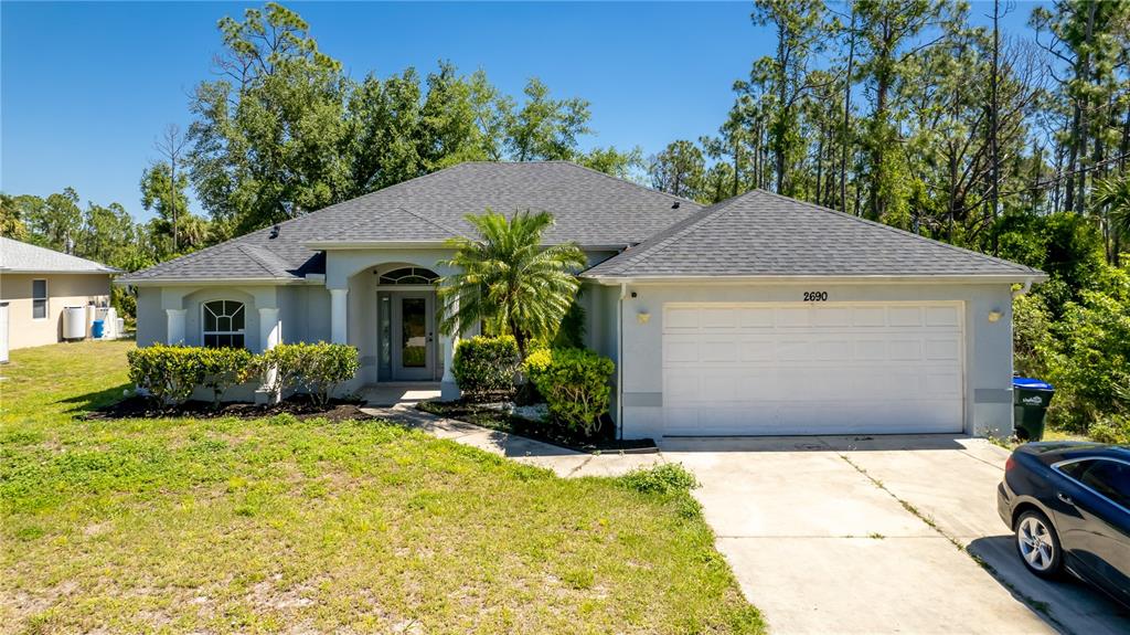 a view of a house with a yard and sitting area