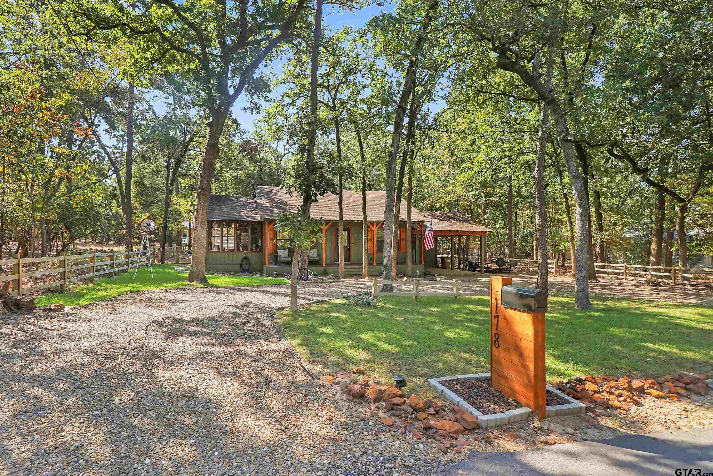 a front view of a house with a yard and trees