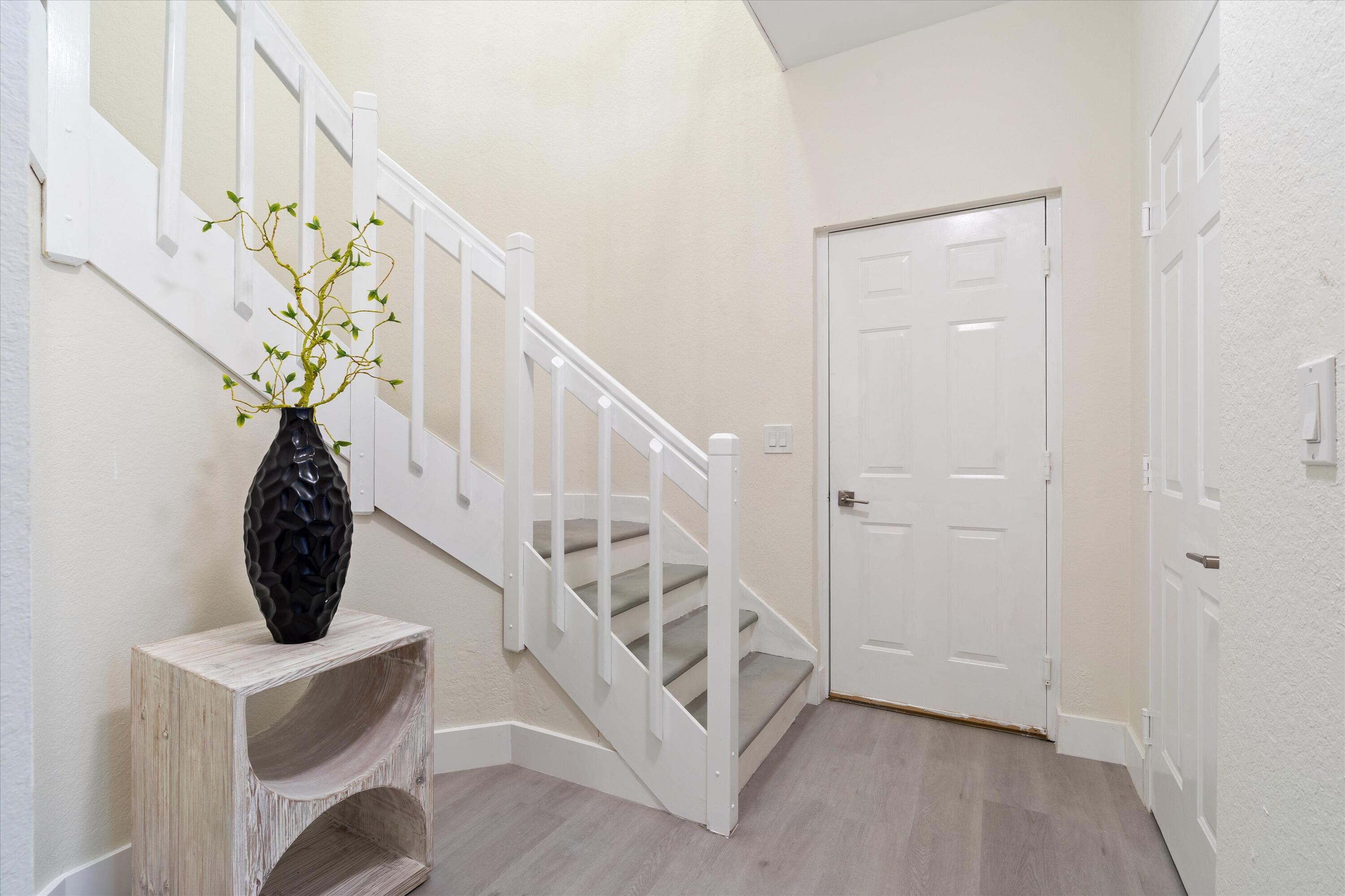 a view of entryway with stairs and wooden floor