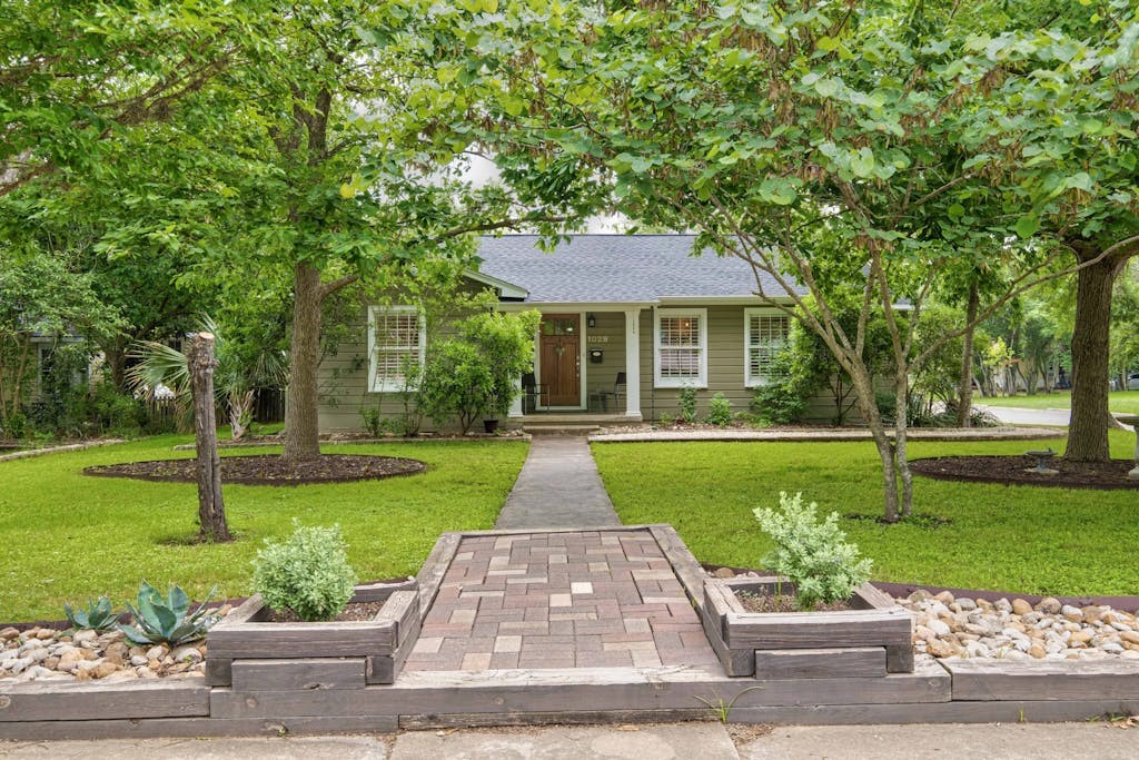 a front view of a house with garden