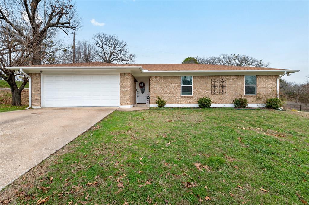 a view of a house with a yard and a garage