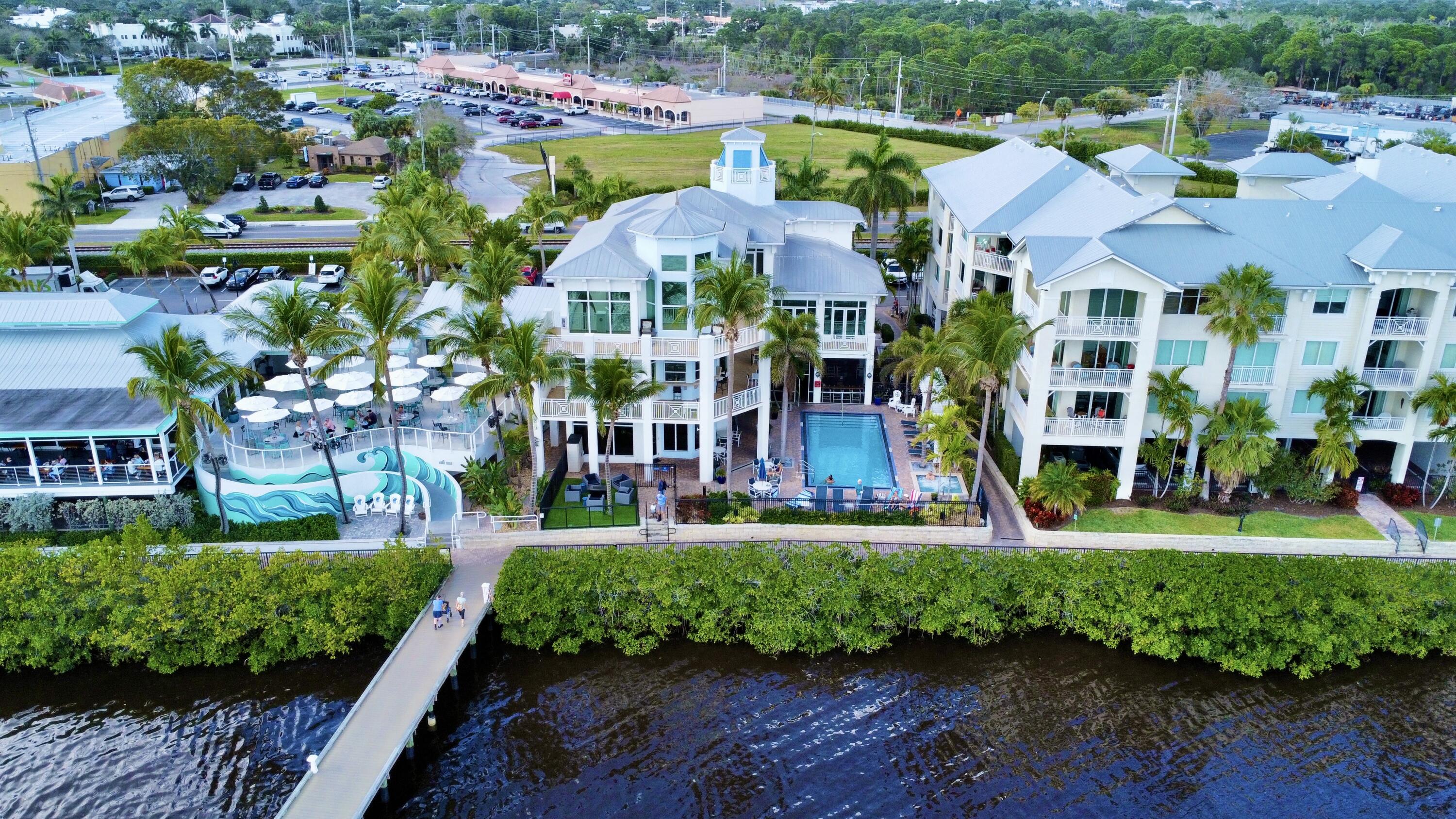 an aerial view of multiple houses with a yard