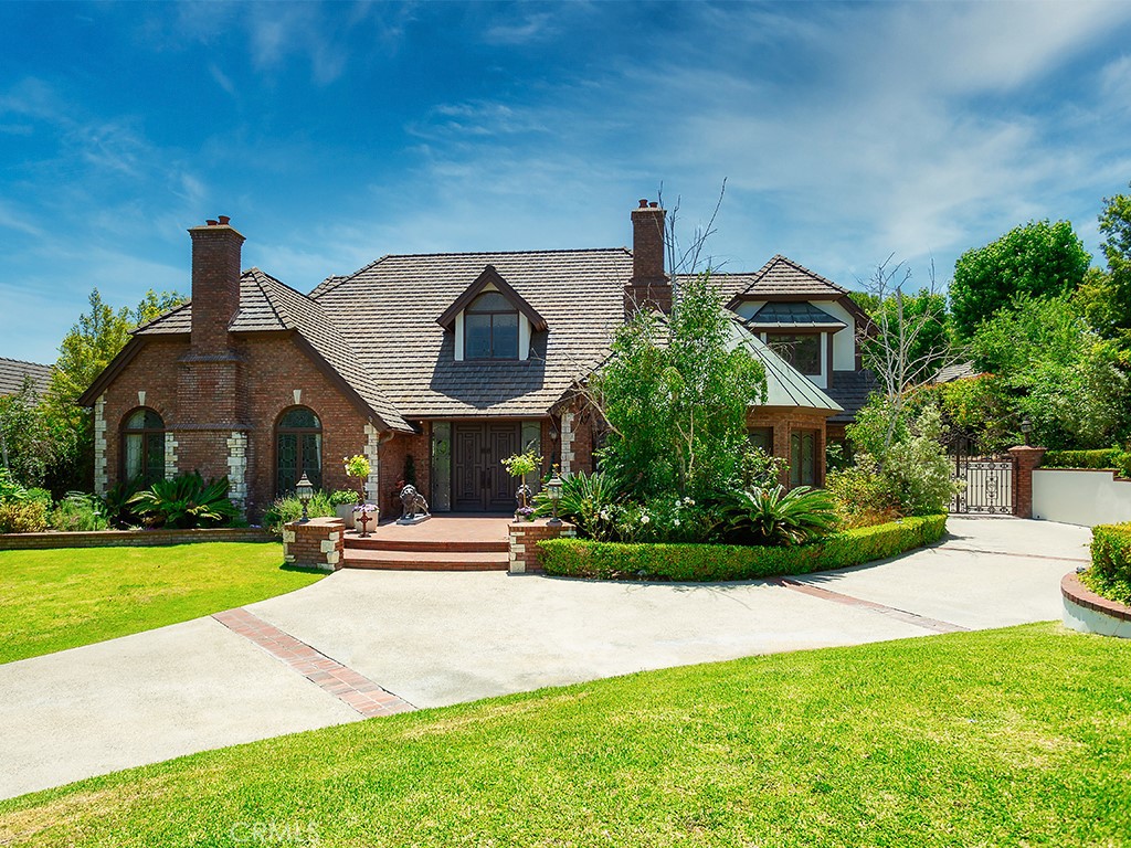 a front view of house with yard and green space