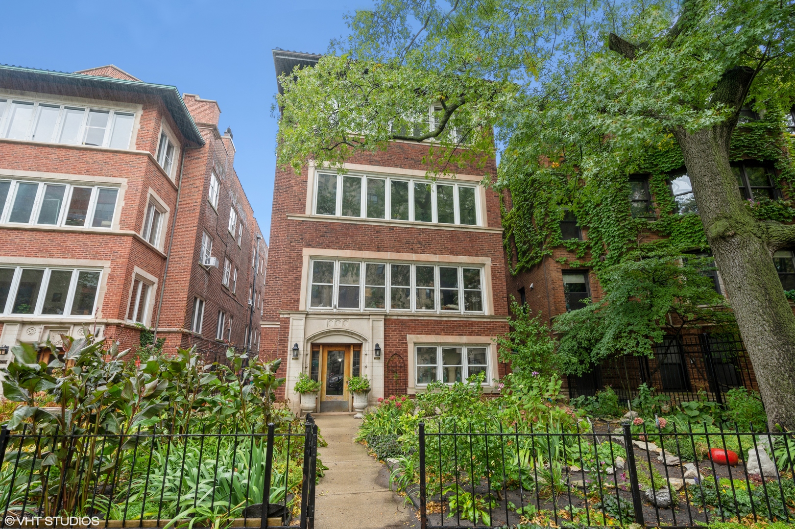 a front view of a building with a garden