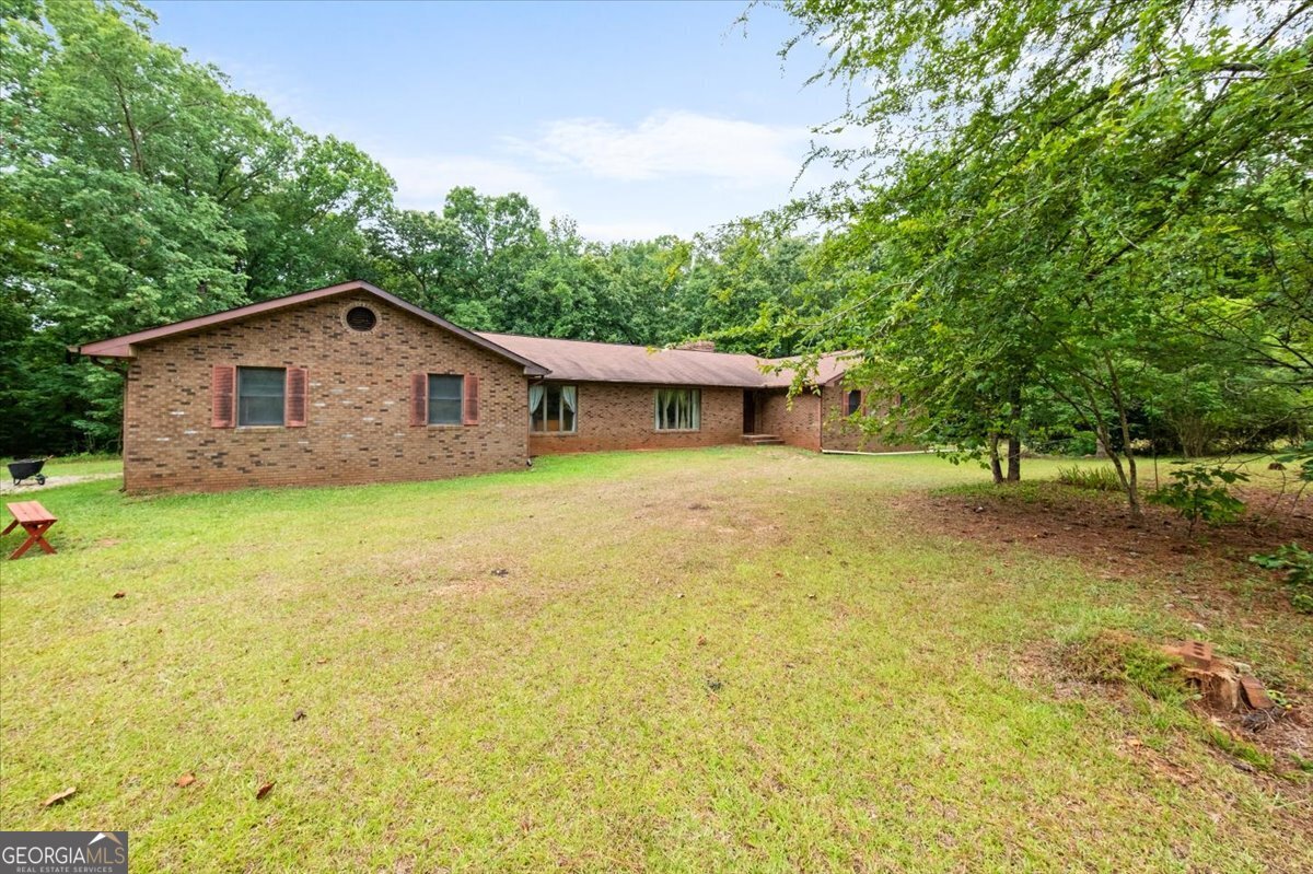 a view of house with a yard