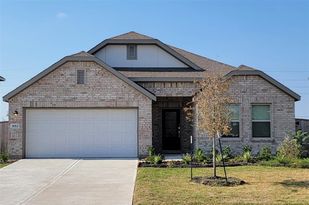 a front view of a house with garage