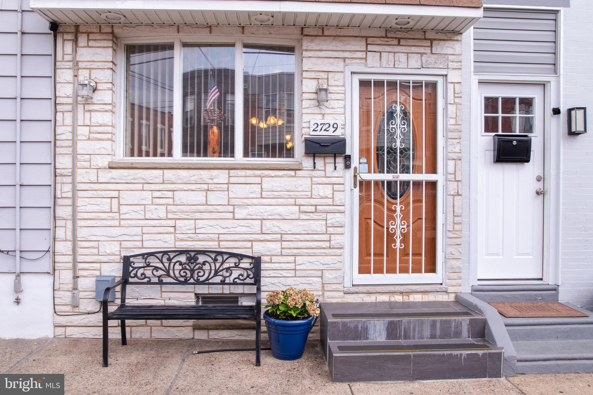 a view of a brick house with a bench