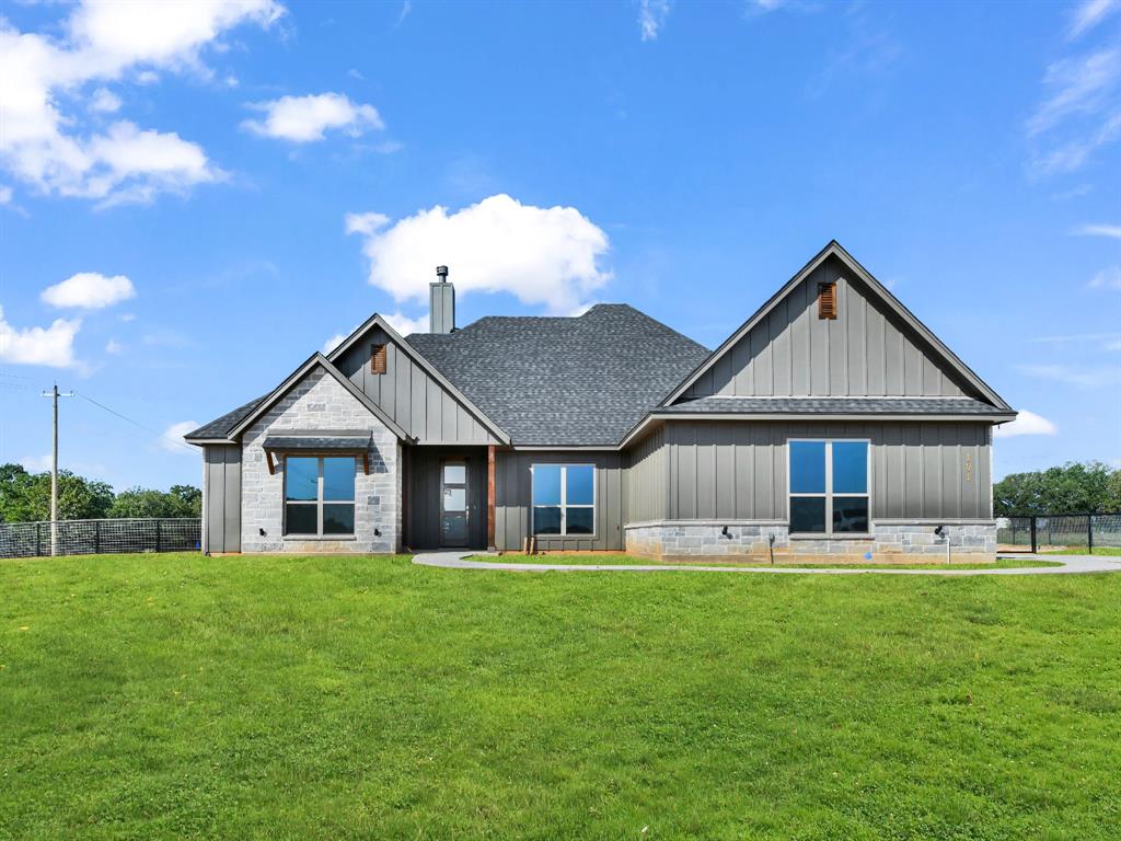 a front view of house with yard and green space