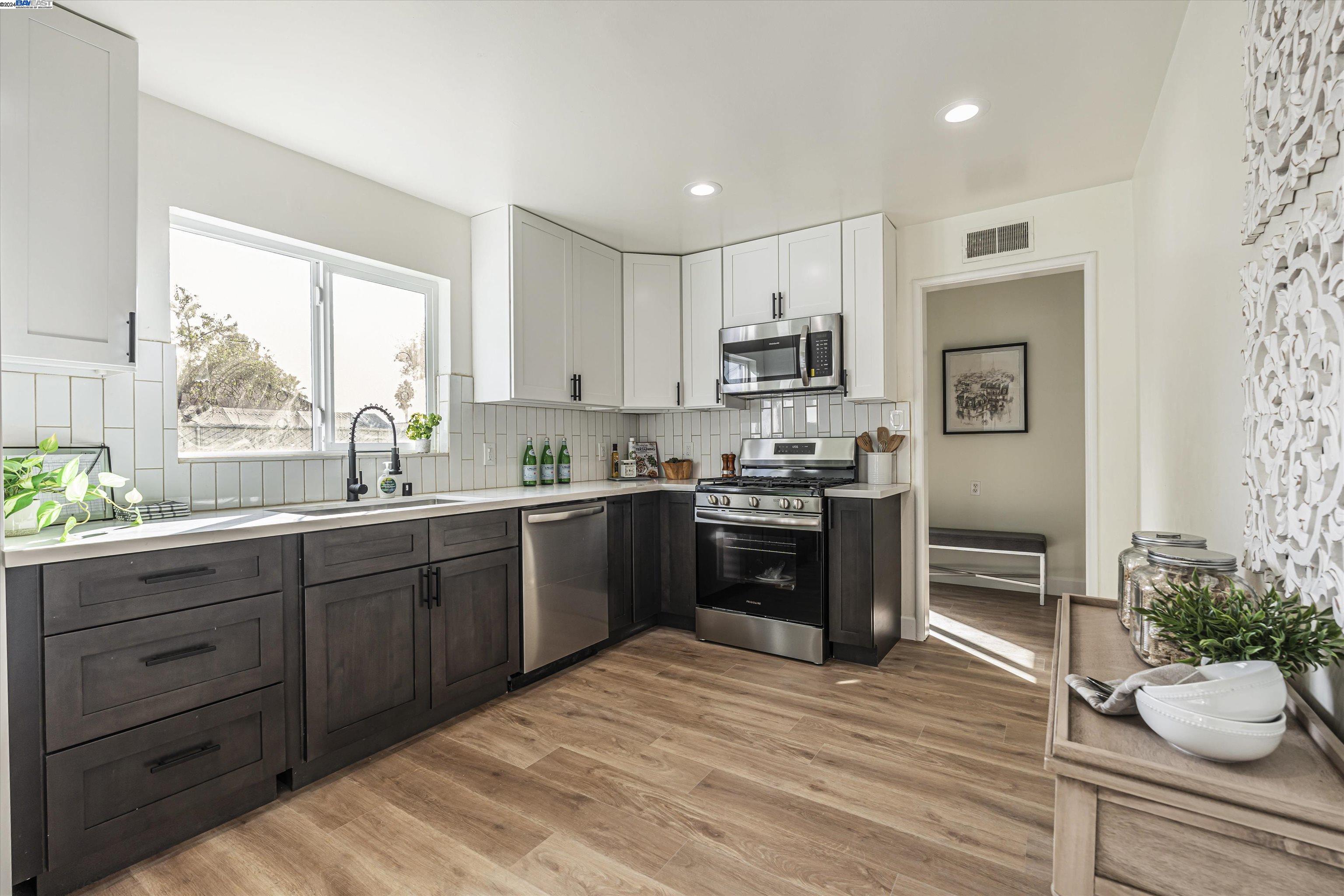 a kitchen with a refrigerator and a stove top oven