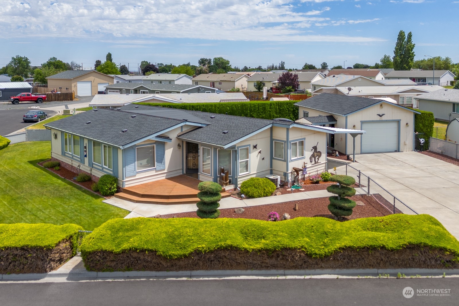 an aerial view of a house with garden space and street view