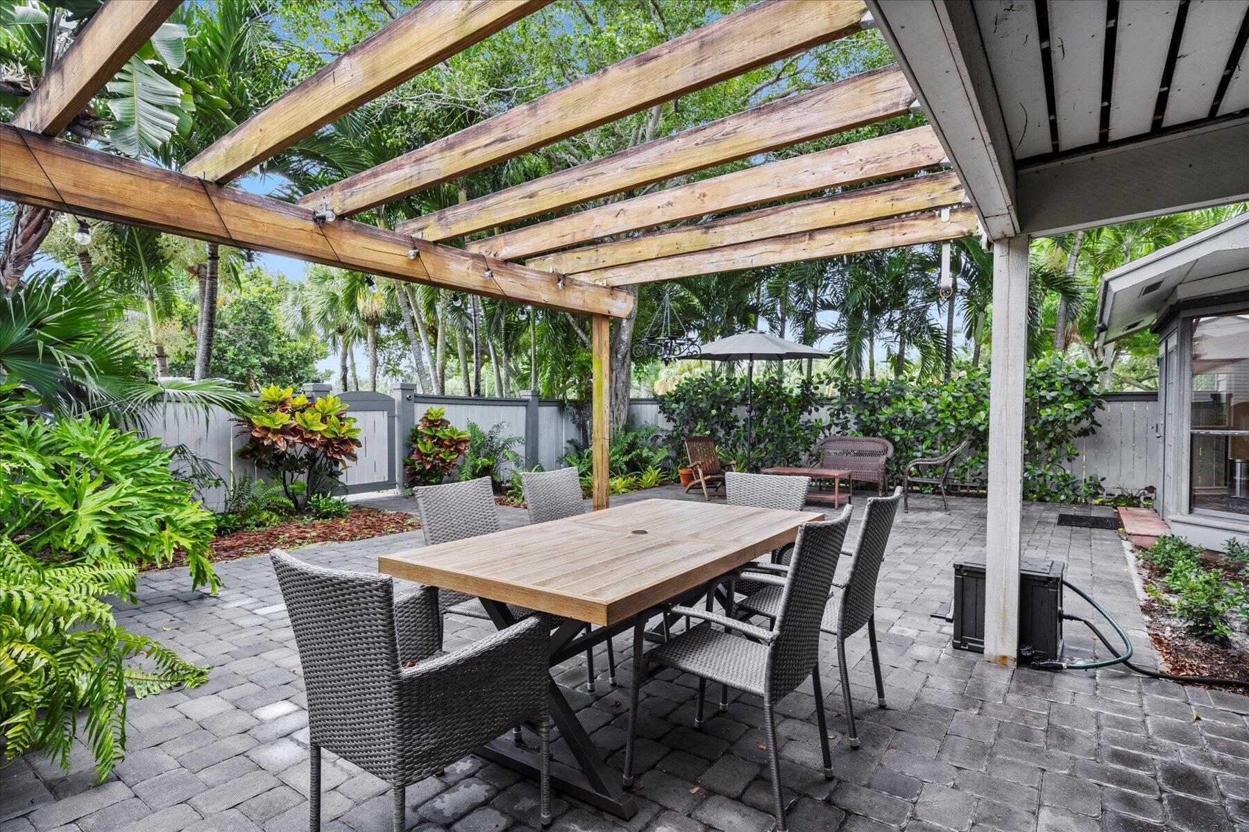 a view of a patio with a table chairs and a backyard