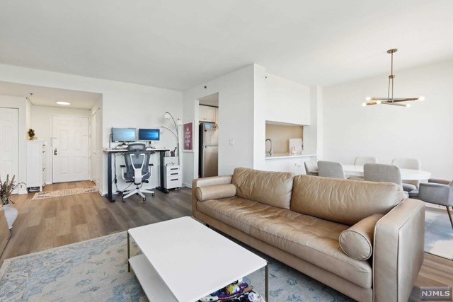 a living room with furniture and kitchen view