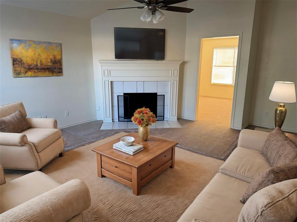 a living room with furniture and a fireplace