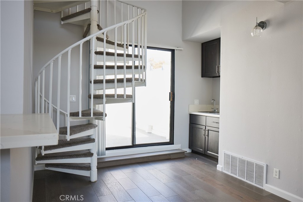 a view of staircase with white walls and railing