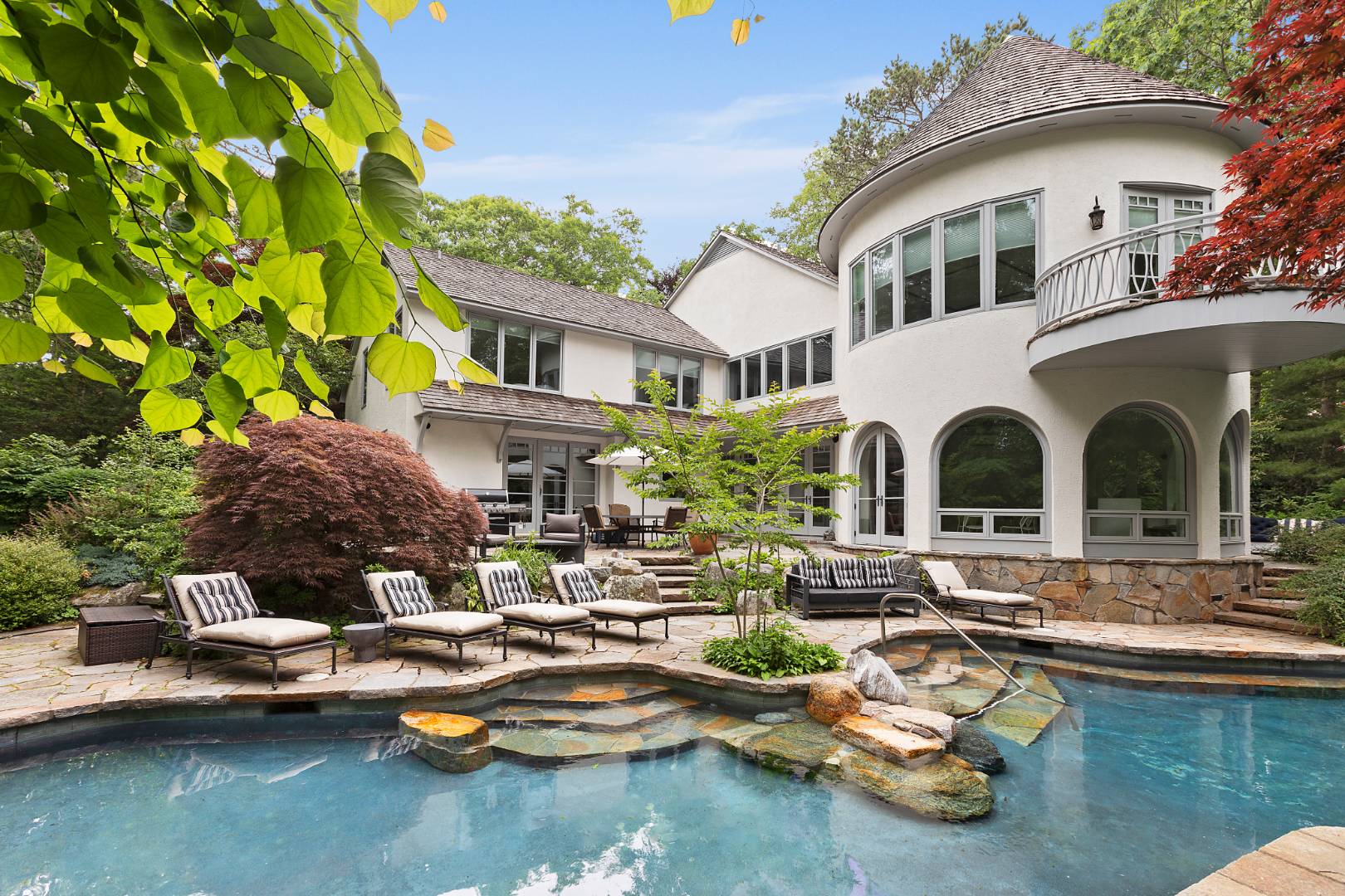 a front view of a house with swimming pool and a yard