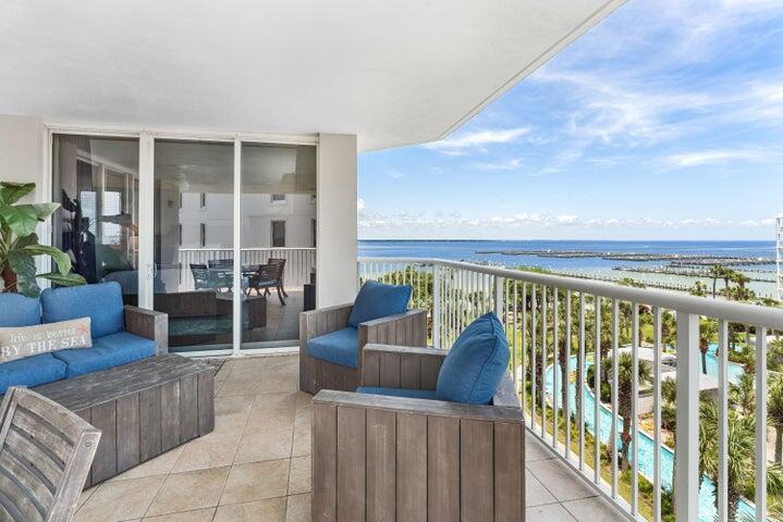 a balcony with furniture and a potted plant