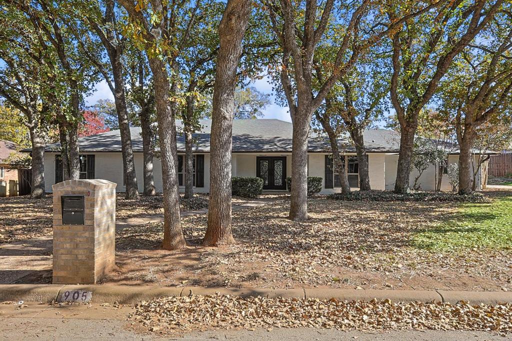 a backyard of a house with barbeque oven