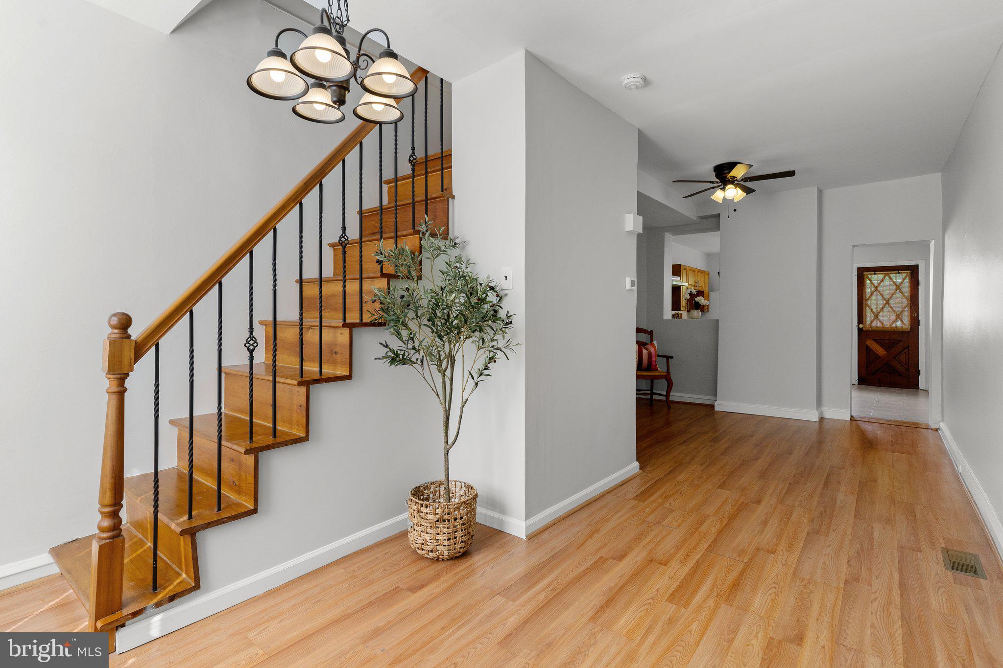 a view of entryway and hall with wooden floor