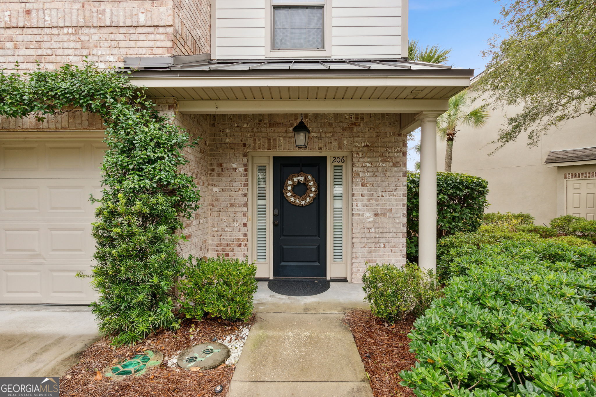 a front view of a house with garden