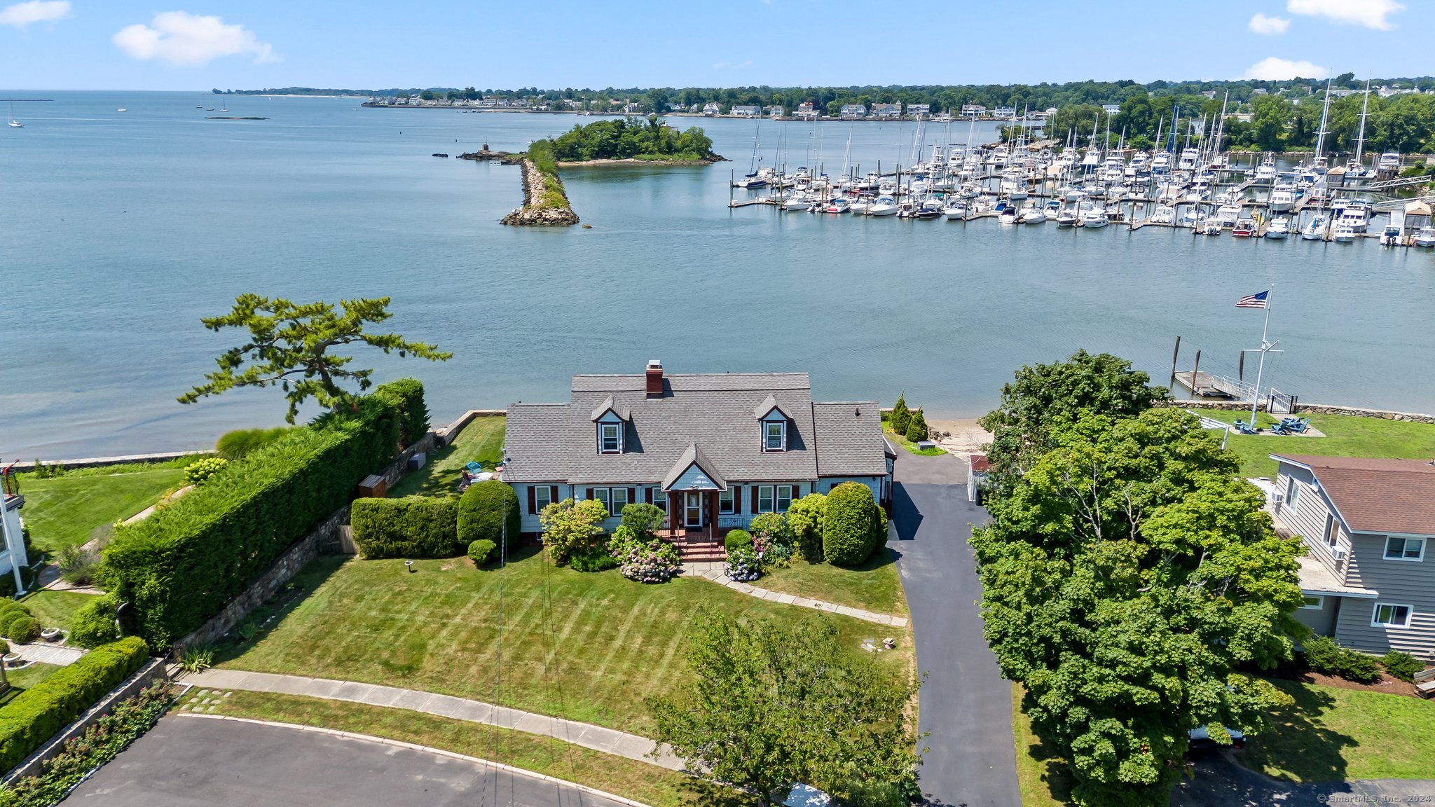 an aerial view of a house with a yard and lake view