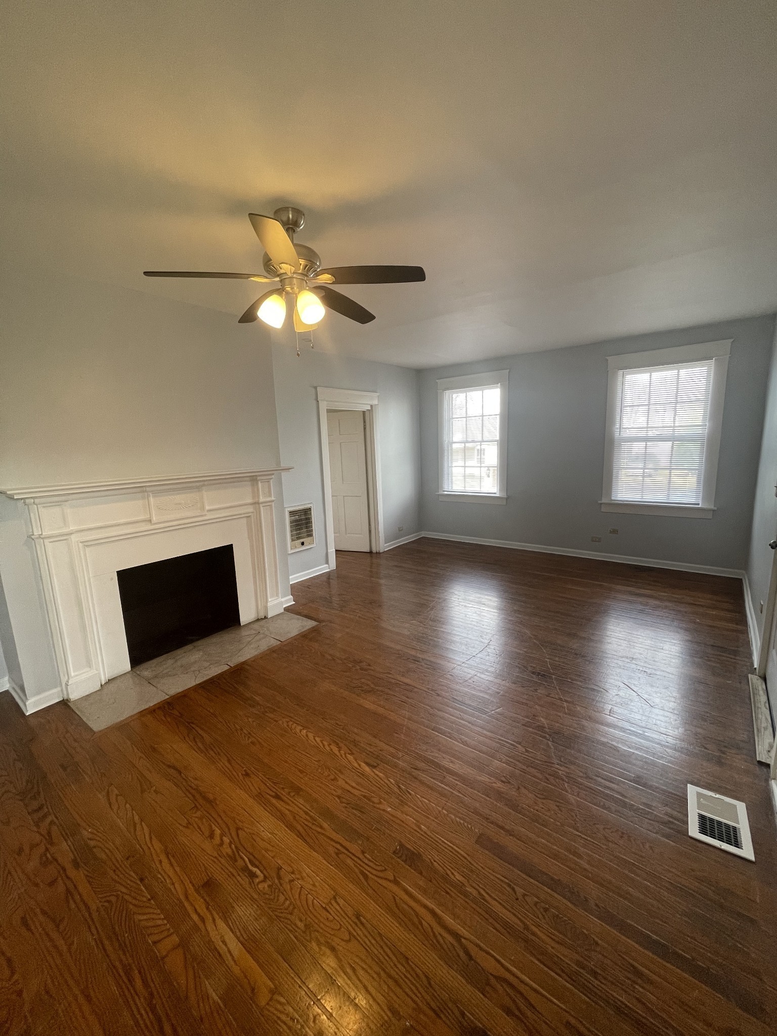 a view of a room window and wooden floor