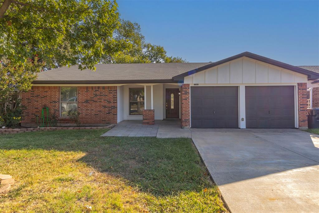 Single story home featuring a front lawn and a garage