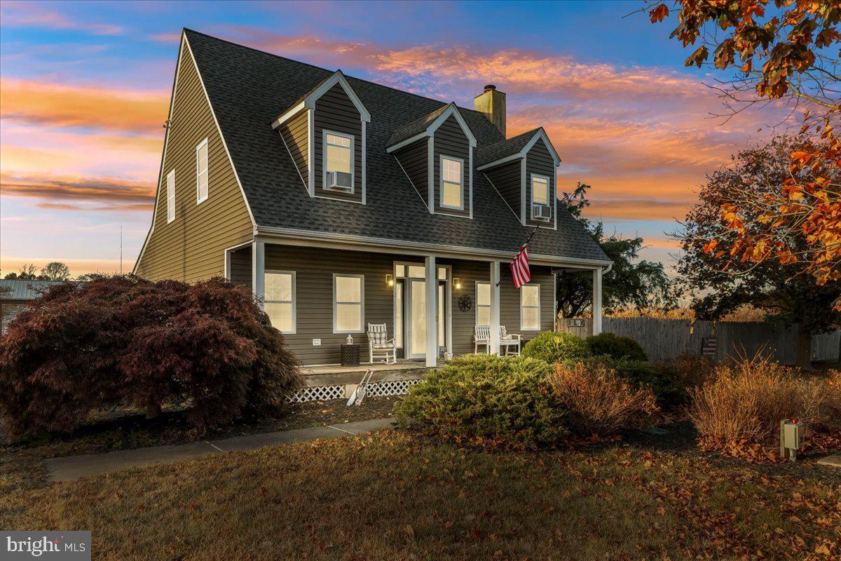 a front view of house with a garden