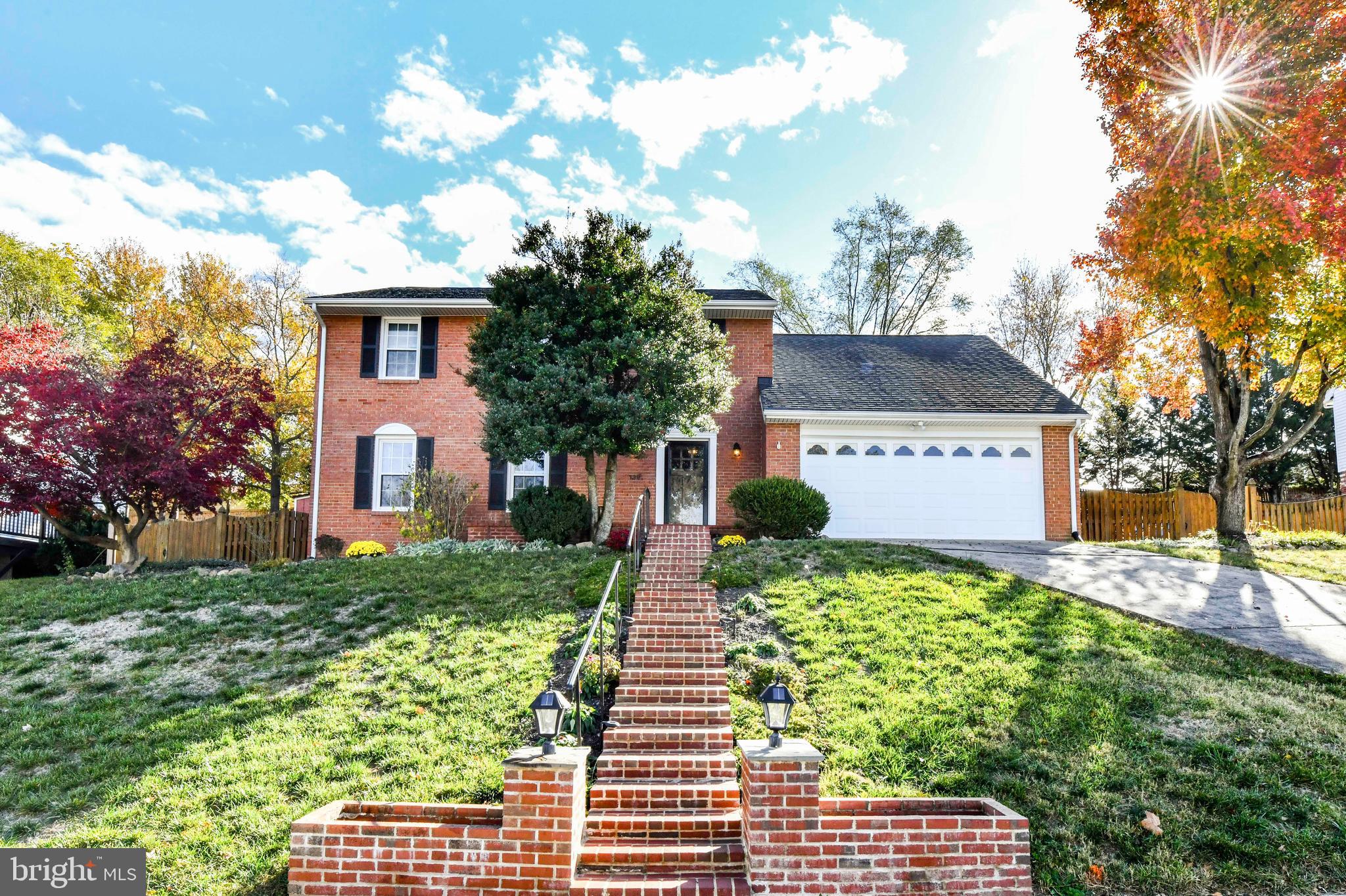 a front view of a house with a yard and potted plants