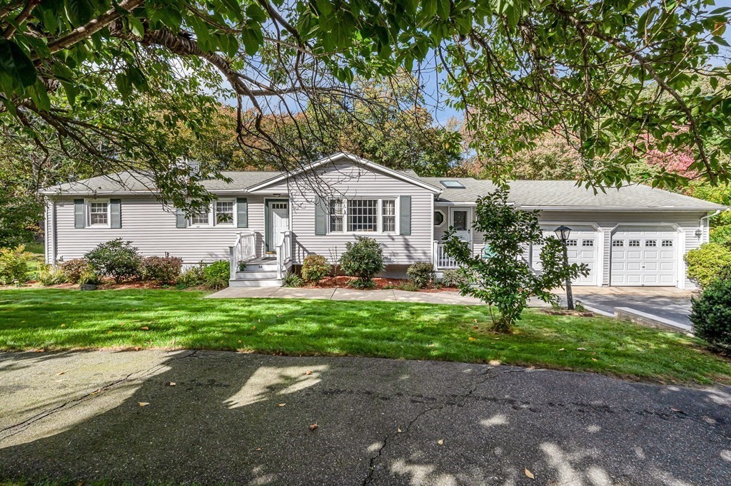 a front view of house with yard and green space