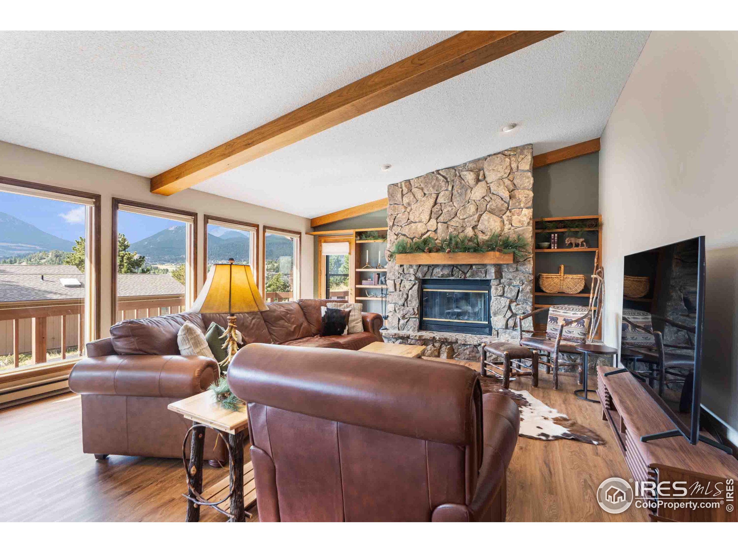 a living room with furniture a flat screen tv and a fireplace