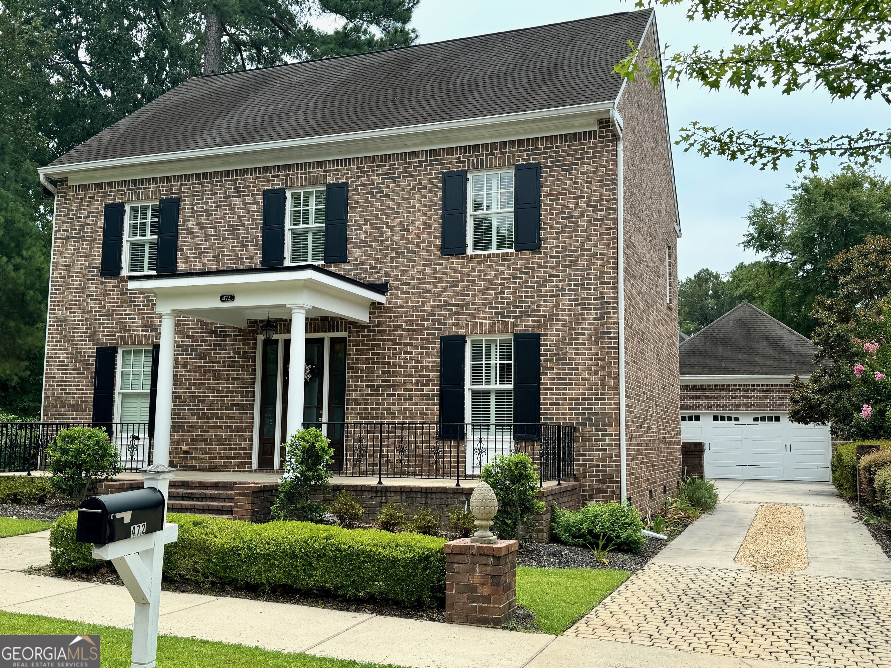 a front view of a house with garden