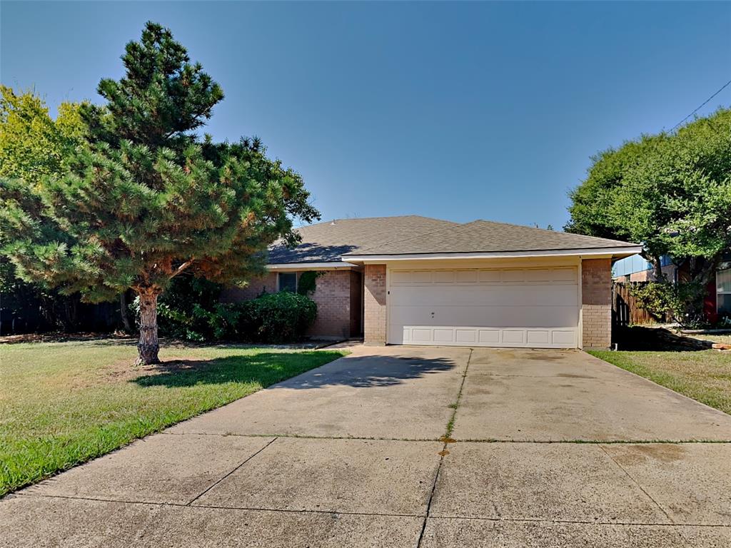 a front view of a house with a yard and a garage