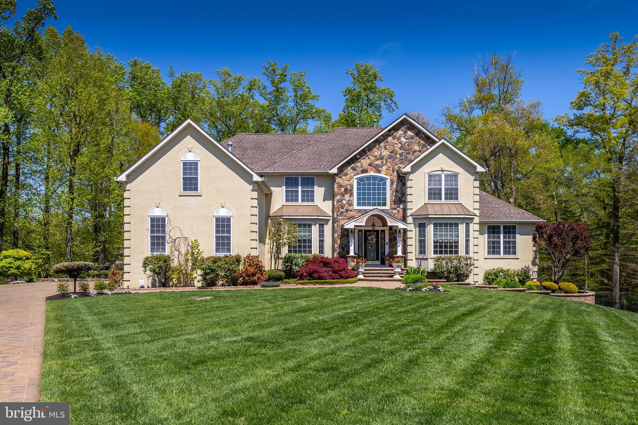 a front view of a house with a garden and plants