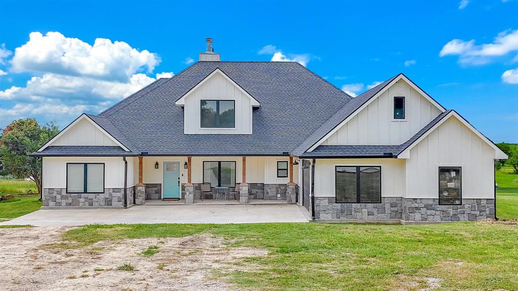 a front view of a house with a yard patio and fire pit