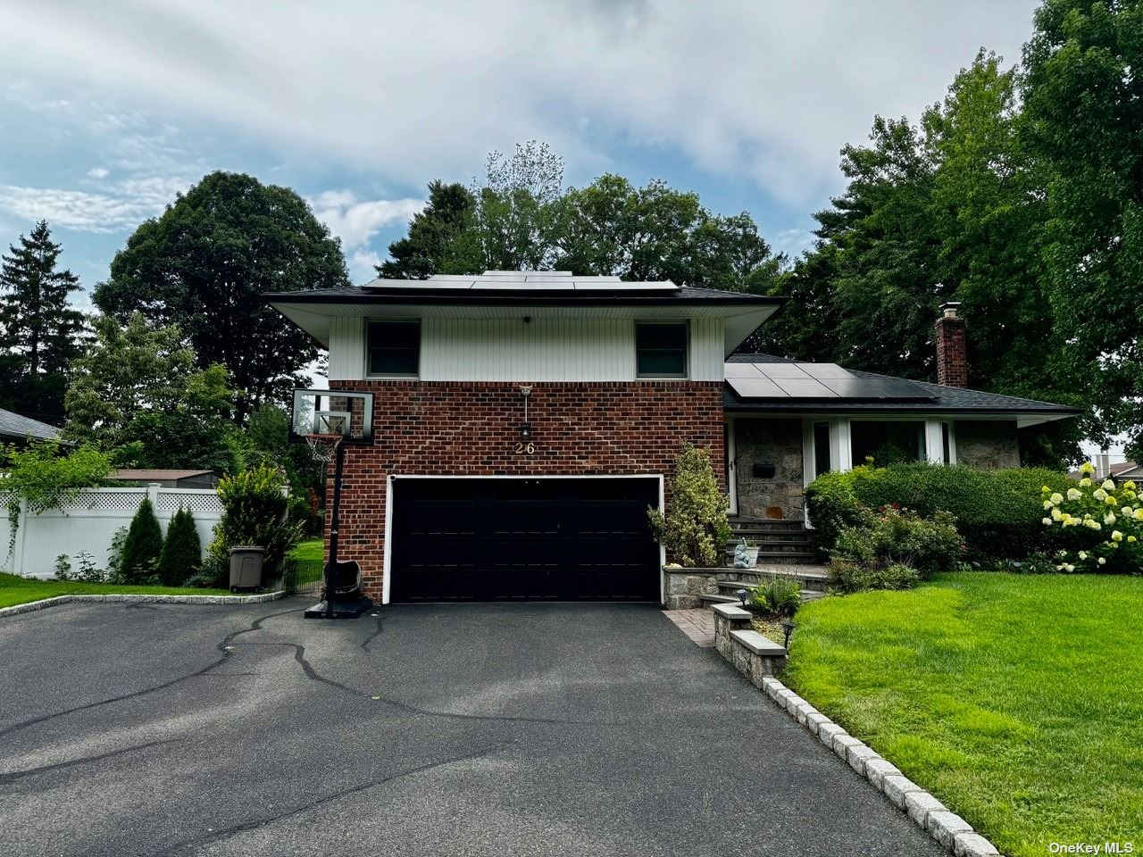 a front view of a house with a garden